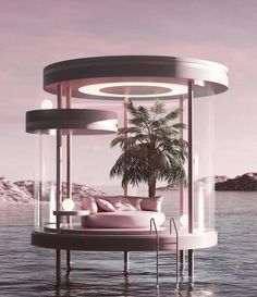 a round bed sitting on top of a body of water next to a palm tree