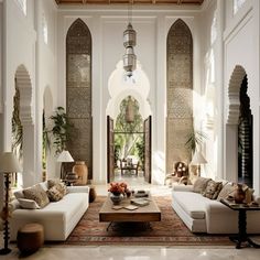 a living room filled with lots of white furniture