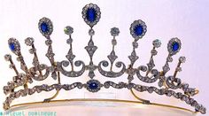 An even better tiara necklace combination, 1890. Designed as five diamond pinnacles, topped with oval sapphires surrounded by diamond clusters, wint smaller diamond spacers, linked by diamond scrolls, on a base of diamonds with a central oval sapphire, and raised on a band of gold. Hair Tiara, Princes Diana