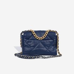 For timeless Parisian-chic there is no better investment than a Chanel flap bag. However, for something both classic and on-trend, the Chanel 19 Flap Bag ticks all boxes. This navy blue shade is unique and particularly sought after; and it will compliment a range of outfits in your wardrobe. The interwoven chain sits elegantly on your shoulder or doubled up on your arm. SPL Exterior Deep blue goatskin exterior Gold, Silver and Ruthenium tone hardware features Signature '19' CC Twist lock closure Short shoulder strap with leather pad for comfort Short Gold chain for handheld purposes Slip pocket at rear of bag 29 series - 2019 Excellent condition - some minor corner rubbing and slight wear to back Interior Navy fabric lining ‘Chanel’ engraved in metal hardware plaque One Zip Pocket Main com Chanel 19 Flap Bag, Chanel 19, Chanel Flap Bag, Navy Fabric, Bottega Veneta Shoulder Bag, Louis Vuitton Shoes, Dior Shoes, Parisian Chic, Love Blue