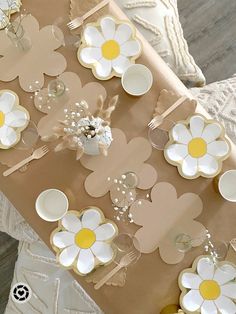 a table topped with paper flowers and plates