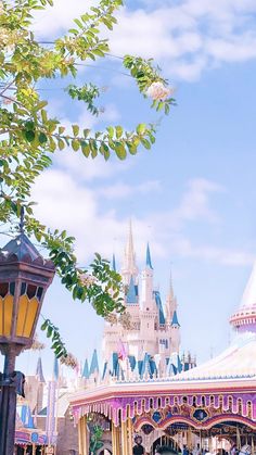 a carousel in front of a castle on a sunny day