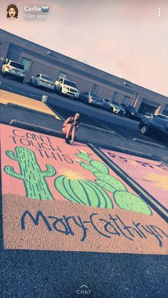 a person kneeling on the ground in front of a parking lot