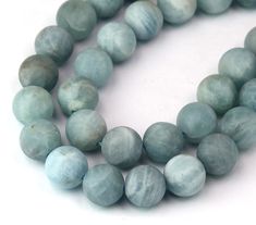 two strands of gray marble beads on a white background