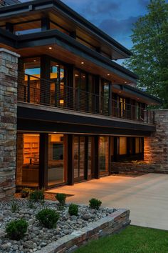 a large house with lots of windows and lights on it's sides at night