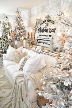 a living room filled with lots of white christmas decorations