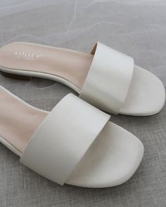 Classic slide flat sandals for casual and dressy look. Simple and easy wear for brides, bridesmaids and wedding parties.DETAILS:COLORS AVAILABLE: Ivory, Light Blue, White, Pink, and ChampagneUPPER: Synthetic upper and liningMATERIALS: Mandmade outsole STYLE NAME: EVELYN Summer Wedding Shoes With Low Heel, Flat Summer Wedding Shoes For Bridesmaids, Elegant Flat Heel Slides For Beach, Summer Flat Heel Bridesmaid Wedding Shoes, Elegant Open Toe Flats With Removable Insole, Elegant Summer Slides With Flat Heel, Chic Flat Heel Wedding Shoes For Summer, Elegant White Open Toe Slides, Chic Open Toe Wedding Shoes For Summer