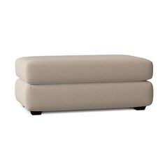 a large beige ottoman sitting on top of a white floor