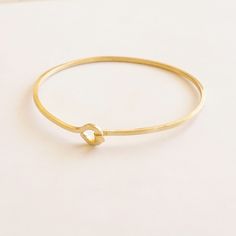 This a beautiful thin square 1.5mm hook and eye bracelet. It is a piece that looks great by itself and even better when accompanied by many more! <> 1.5mm Raw Gold Colored Brass, Sterling Silver or 14k Gold Filled <> Packaged in Kraft Box This bracelet is measured as a bangle, so you will want to measure the widest part of your fist to determine the size you are looking for. If you have any questions about it, please let me know! About Gold-Filled All gold-filled jewelry sold by Pati Raw Gold, Minimalist Bangle, Jewelry Stacking, Artistic Wire, Brass Bangle, Bracelet Minimalist, Brass Bracelet, Pretty Necklaces, Stacked Jewelry