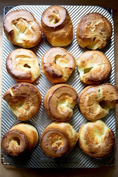 there are many rolls that have been baked on the tray and ready to be eaten