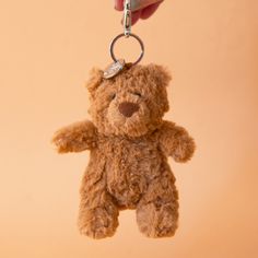 On a tan background is a brown bear stuffed toy on a silver loop and hook for adding to a bag or keychain. Jellycat Keychain, Jellycat Wishlist, Bartholomew Bear, Bear Bag, Bear Keychain, Diy Crafts To Do, Charm Keychain, Sponge Cleaning, Car Stuff