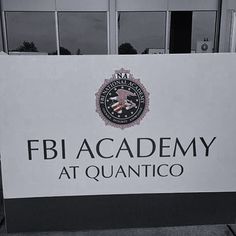 a sign that says fijacademy at quanntico in front of a building