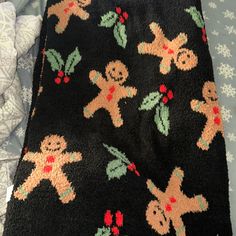 a black blanket with gingerbread men on it