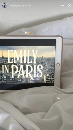 an ipad with the words family in paris on it sitting on top of a bed