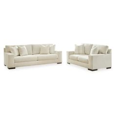 two white couches sitting next to each other