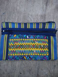 Beautiful little cotton accessory bag made from handwoven Guatemala textile. This Woven tribal pouch is perfect for travel or just hanging out and can be used in a myriad of ways. Large zippered compartment is just enough to hold all your essentials, some lipstick or lip gloss, ID's, and even your wallet and smartphone. Inside is fully lined. You won't be disappointed with this stunning accessory bag. Quality made and Woven with bold colors in an intricate pattern . This listing is for one trave Handwoven Pouch For Daily Use, Handmade Blue Travel Pouch, Blue Bohemian Rectangular Pouch, Bohemian Pouch Wallet For Everyday Use, Multicolor Woven Pouch For Everyday Use, Bohemian Style Pouch Coin Purse For Everyday, Woven Travel Pouch, Blue Bohemian Pouch For Everyday Use, Handwoven Rectangular Pouch For Travel