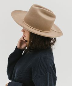 Ezra blends statement fashion with Western. A classic cattleman crown made to be styled for the city as much as the countryside. This hat features an upturned brim + a tall crown, giving Ezra a modern + feminine feel. Ezra comes with a removable tonal grosgrain band featuring a brass Gigi Pip pin. Other bands pictured are sold separately. Fall Flat Brim Top Hat, Classic Wide Brim Panama Hat For Fall, Classic Wide Brim Boater Hat For Fall, Fitted Flat Brim Fedora For Everyday, Classic Unlined Flat Brim Fedora, Everyday Fitted Fedora With Flat Brim, Everyday Fitted Flat Brim Fedora, Classic Boater Hat With Flat Crown For Fall, Classic Wide Brim Top Hat For Spring