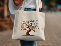 Introducing our enchanting Tree of Life Tote Bag - a vibrant and stylish accessory that seamlessly blends functionality with artistic flair! Elevate your everyday with this stunning tote featuring a mesmerizing and colorful rendition of the Tree of Life, symbolizing growth, strength, and interconnectedness. 🌳 Design: The intricate and lively Tree of Life design on this tote bag is a visual feast, with its vibrant colors and detailed patterns. Each element tells a story, making it not just a bag Trees And Clouds, Tree Of, Boho Tote Bag, Tree Of Life Design, Boho Tote, Colorful Trees, Boho Gifts, Bag Canvas, Life Design