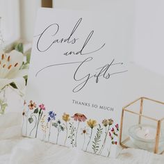 a card that says cards and gifts on it next to a vase with flowers in it