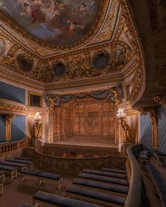 an ornately decorated auditorium with blue seats