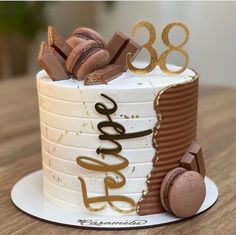 a birthday cake decorated with chocolate and macaroons