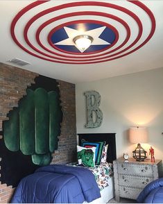 a bedroom decorated in red, white and blue with an american flag painted on the ceiling