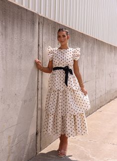 Unleash your unique style with our Impossibly Chic Midi Dress. Featuring a playful polka dot design and elegant tiered layers, it's the perfect balance of fun and class. The charming bow waist design adds a touch of sophistication to any occasion. Elevate your wardrobe with this must-have dress. Fabric 100% polyester Polka Dot Tiered Dress With Ruffles, Tiered Polka Dot Dress With Ruffles, Feminine Polka Dot Dress With Ruffle Hem, Chic Midi Dress, Midi Dress Chic, Polka Dot Design, Dot Design, New Tops, Dress Fabric