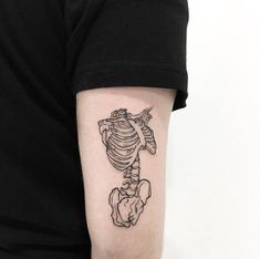 a man's arm with a skeleton tattoo on the left side of his arm