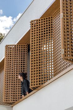 a woman is standing on the balcony railing