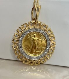 "Original 22k gold \"lady liberty\" coin mounted in a diamond bezel pendant. This pendant has a well-contrasted white and yellow gold setting and double rhodium-plated finish for lifelong use. ✔ Metal: Gold ✔ Metal Purity: 22K ✔ Carat Weight(s): 0.75ct in diamonds ✔ Item Weight: 10.7 grams ✔ Item Size: 1 - 1/4 inch x 1 - 1/8 ✔ Stone Count: 20 diamonds ✔ 1/10 Oz Gold Coin Value ✔ Coin Purity: 91.67% gold (22 karat), 3% silver, 5.33% copper ✔ Coin Gold Weight: 1/10 oz. - 0.1000 ounces (0.1091 gros 5 Dollar, Copper Coin, Round Diamond Setting, Copper Coins, Lady Liberty, Square Earrings Studs, Bezel Pendant, Yellow Gold Setting, Square Stud