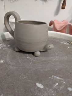 a gray mug sitting on top of a table