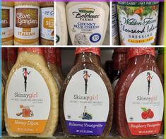 several different types of sauces on display in a grocery store, including honey and blueberry