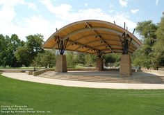 a covered area with steps and trees in the background