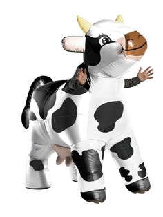 an inflatable cow costume is being carried by a man on a white background