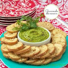 a platter with crackers and dip on it