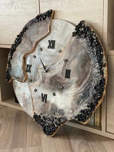 a clock made out of an oyster shell with roman numerals on the face