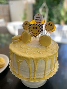 a birthday cake with smiley faces on it