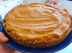 a person holding a plate with a pie on it