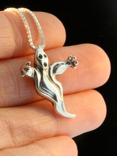 "Float into the \"Spirit\" of Halloween wearing this whimsical Ghost Charm. The Ghost is 1 inch high, solid sterling silver and detailed both front and back. All Marty Magic Charms and Pendants include an 18 inch (46cm) box chain. If you would prefer a different length of chain please feel free to contact me. All Marty Magic Jewelry is packaged in a beautiful box, embossed with the gold foil Marty Magic dragon logo. Perfect for any occasion. This item usually ships the same or next business day! Gothic Sterling Silver Charms Jewelry, Gothic Sterling Silver Jewelry With Charms, Halloween Sterling Silver Pendant Necklace, Silver Halloween Charms Necklace, Silver Charms Necklace For Halloween, Sterling Silver Necklaces For Halloween Gift, Novelty Silver Necklaces With Charms, Silver Novelty Necklaces With Charms, Handmade Themed Sterling Silver Jewelry