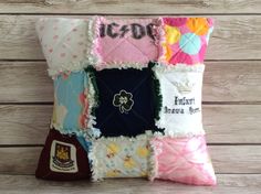 a decorative pillow made out of many different types of fabrics and fabric on wood planks