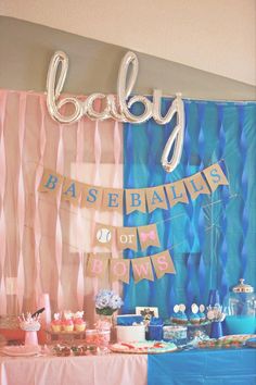 a baby shower party with balloons, cake and desserts on a table in front of a backdrop