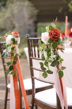 the chairs are decorated with roses and greenery for an elegant wedding reception at this outdoor venue