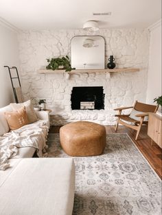 a living room filled with furniture and a fire place next to a wall mounted mirror