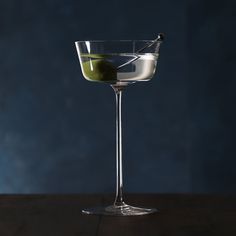 a martini glass with an olive in it