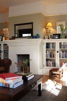 a living room filled with furniture and a fire place in the middle of a room