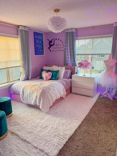 a bedroom decorated in purple and white with pink accents