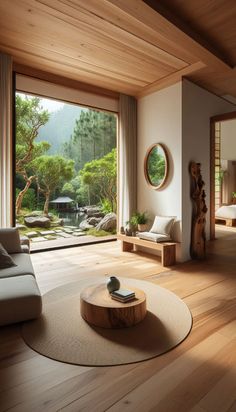 a living room filled with furniture and a large glass door leading to a forest view