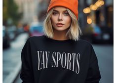 This crewneck is perfect for football fans and sports enthusiasts alike. Whether you're cheering on your favorite team at a game or just showing off your love for sports, this crewneck is a must-have. Made with high-quality materials, it's comfortable and durable for everyday wear. Get ready to show your team spirit with the Yay Sports Crewneck! SIZING -If you are looking for an over-sized look please size up 1-3 sizes from what you normally wear. -Please see sizing chart -These are unisex shirts, this means they will have a loose fit **I do not accept returns or exchanges due to sizing issues - please reference sizing chart in product images prior to purchase PRINT COLOR & SIZING -Please be aware, the color of the print in the shirt may vary slightly from what you see on your screen due t Black Tops With Ribbed Cuffs For Game Day, Collegiate Style Activewear For Game Day, Black Graphic Print Sweatshirt For Game Day, Collegiate Streetwear Sweatshirt For Baseball Season, Black Long Sleeve Sweatshirt For Game Day, Fall Sports Hoodie With Crew Neck, Fall Sports Crew Neck Hoodie, Trendy Fleece Sweatshirt For Sports, Trendy Crew Neck Activewear For Sports