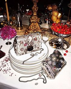 a table topped with lots of plates covered in jewelry