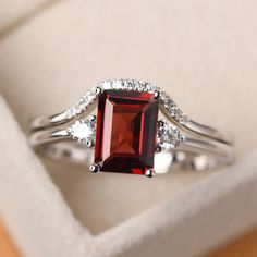 Garnet Emerald Cut Promise Ring, Emerald Cut Garnet Promise Ring, Emerald Cut Garnet Anniversary Ring, Emerald Cut Garnet Ruby Ring With Accent Stones, Emerald-cut Garnet Gemstone Rings, Emerald Cut Garnet Gemstone Rings, Silver Emerald-cut Garnet Jewelry, Emerald Cut Garnet Jewelry For Weddings, Silver Garnet Jewelry With Emerald Cut